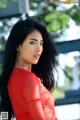 A woman in a red dress posing for a picture.