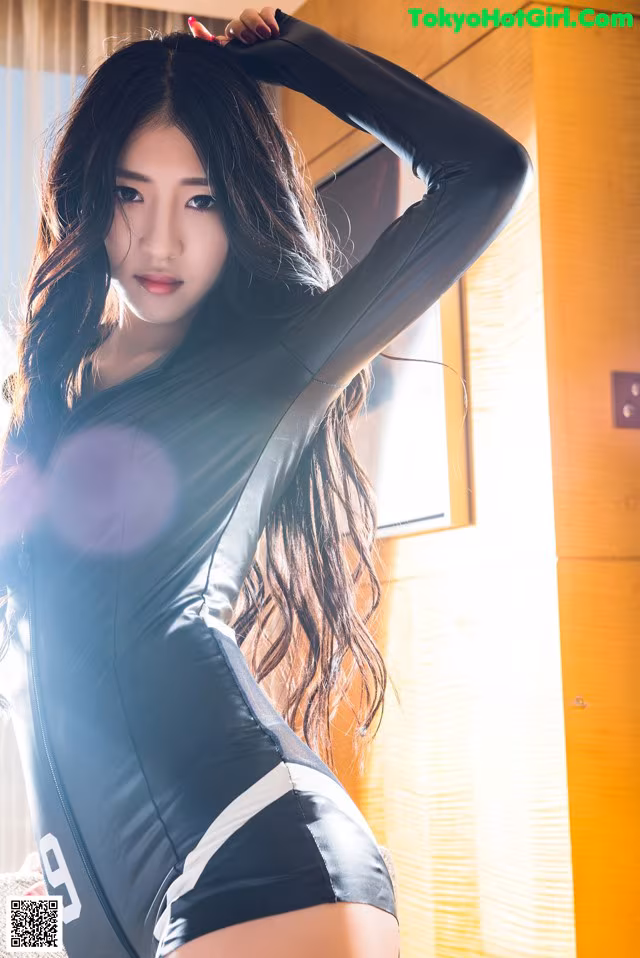 A woman in a black and white outfit posing for a picture.