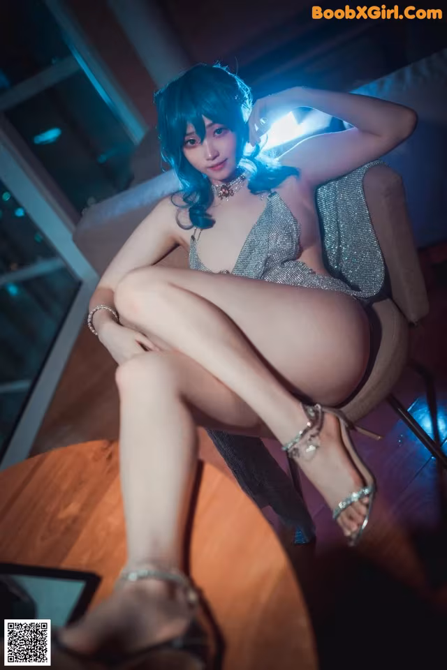 A woman sitting on top of a chair in a room.