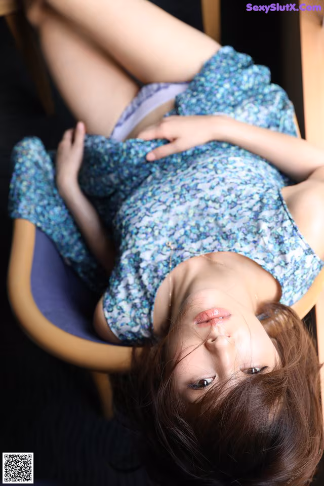 A woman laying on a chair with her legs crossed.