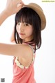 A young woman wearing a straw hat is posing for a picture.