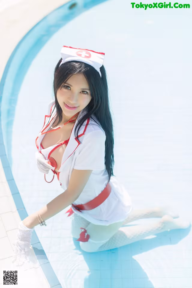 A woman dressed as a nurse sitting on the edge of a pool.